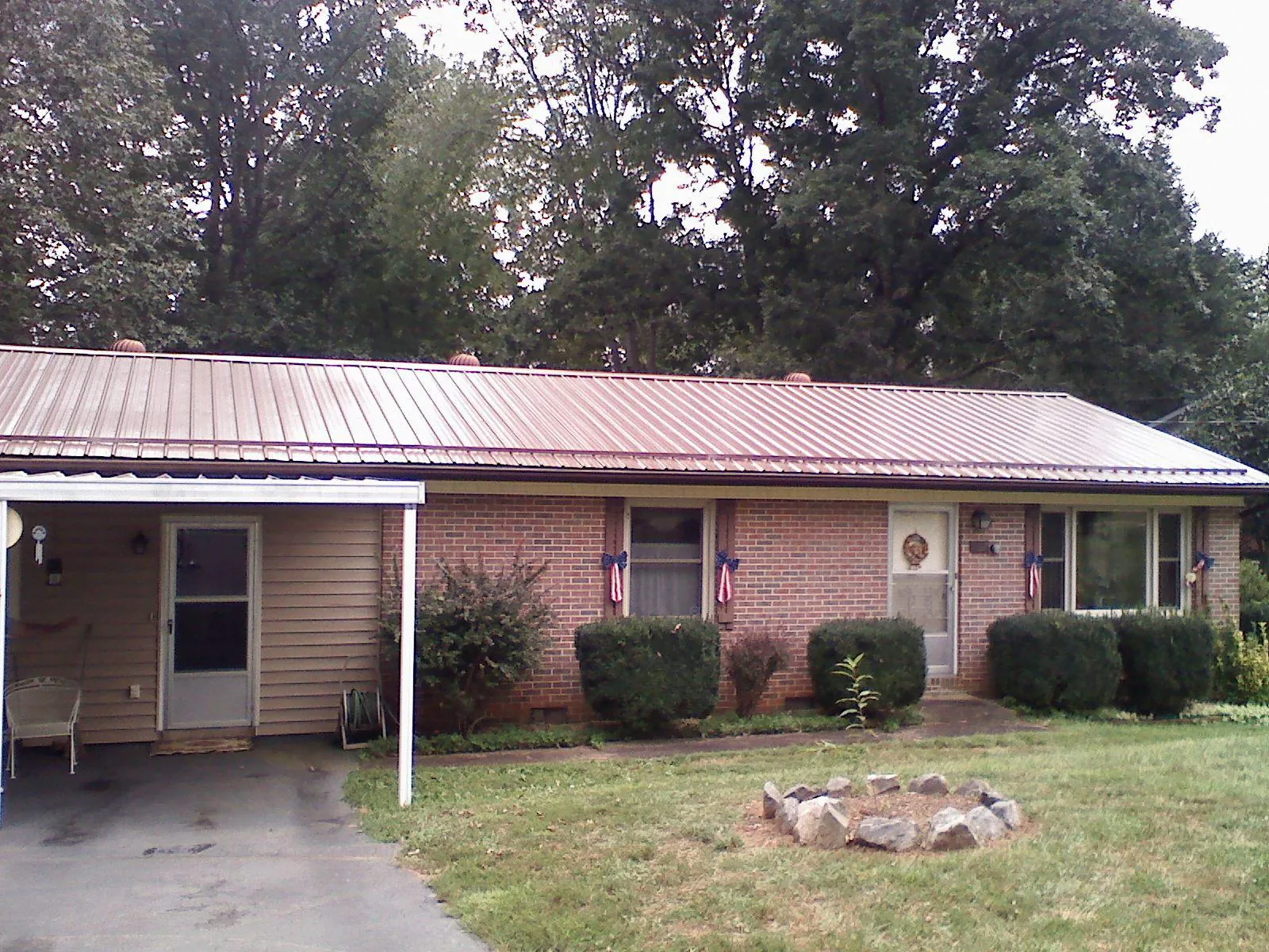 Bronze metal roof and carport on a brick ranch home — Roof Repair work by our crew in Elkins Park